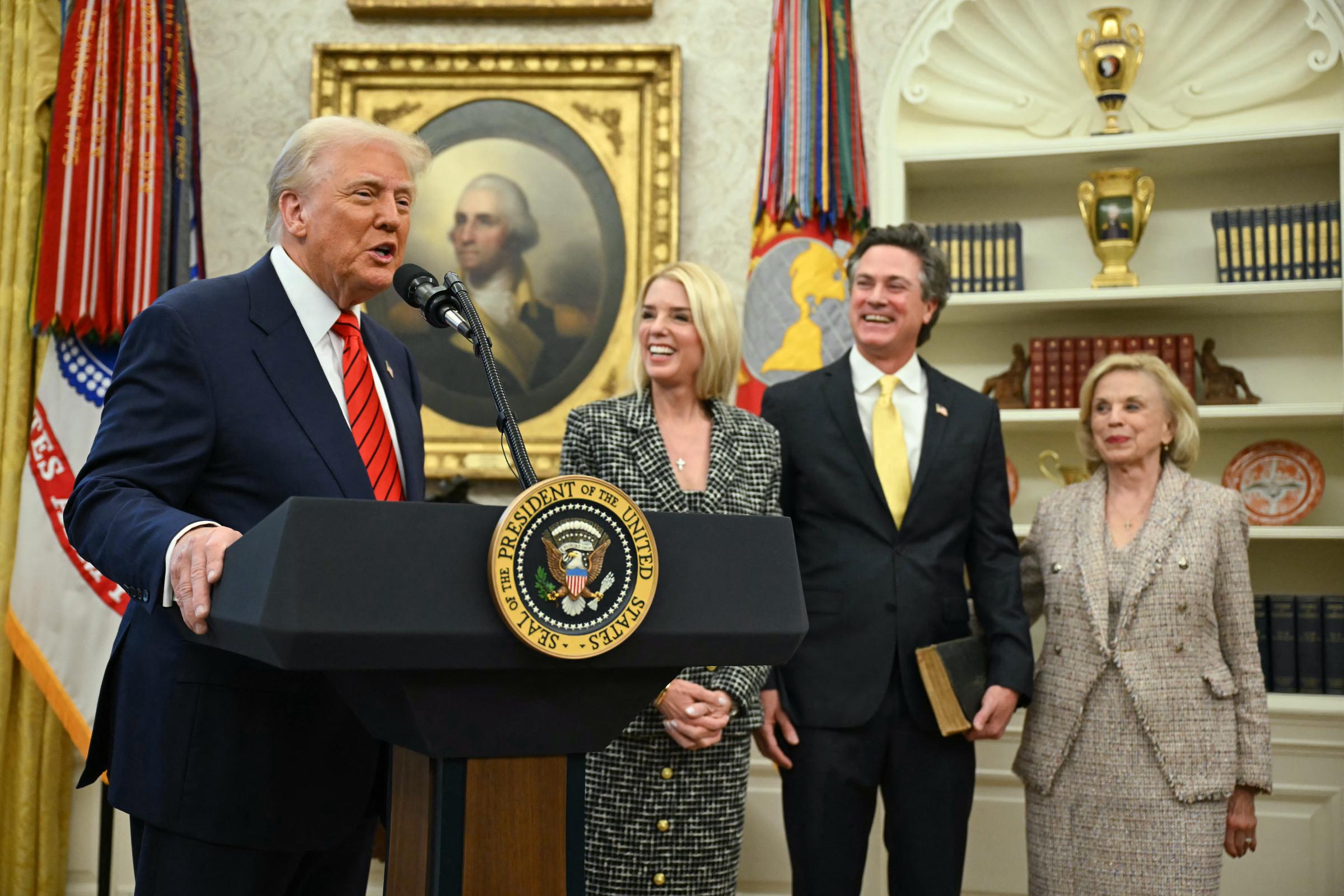 Donald Trump speaks during Pam Bondi's swearing-in ceremony as John Wakefield and Patsy Bondi stand nearby | Source: Getty Images