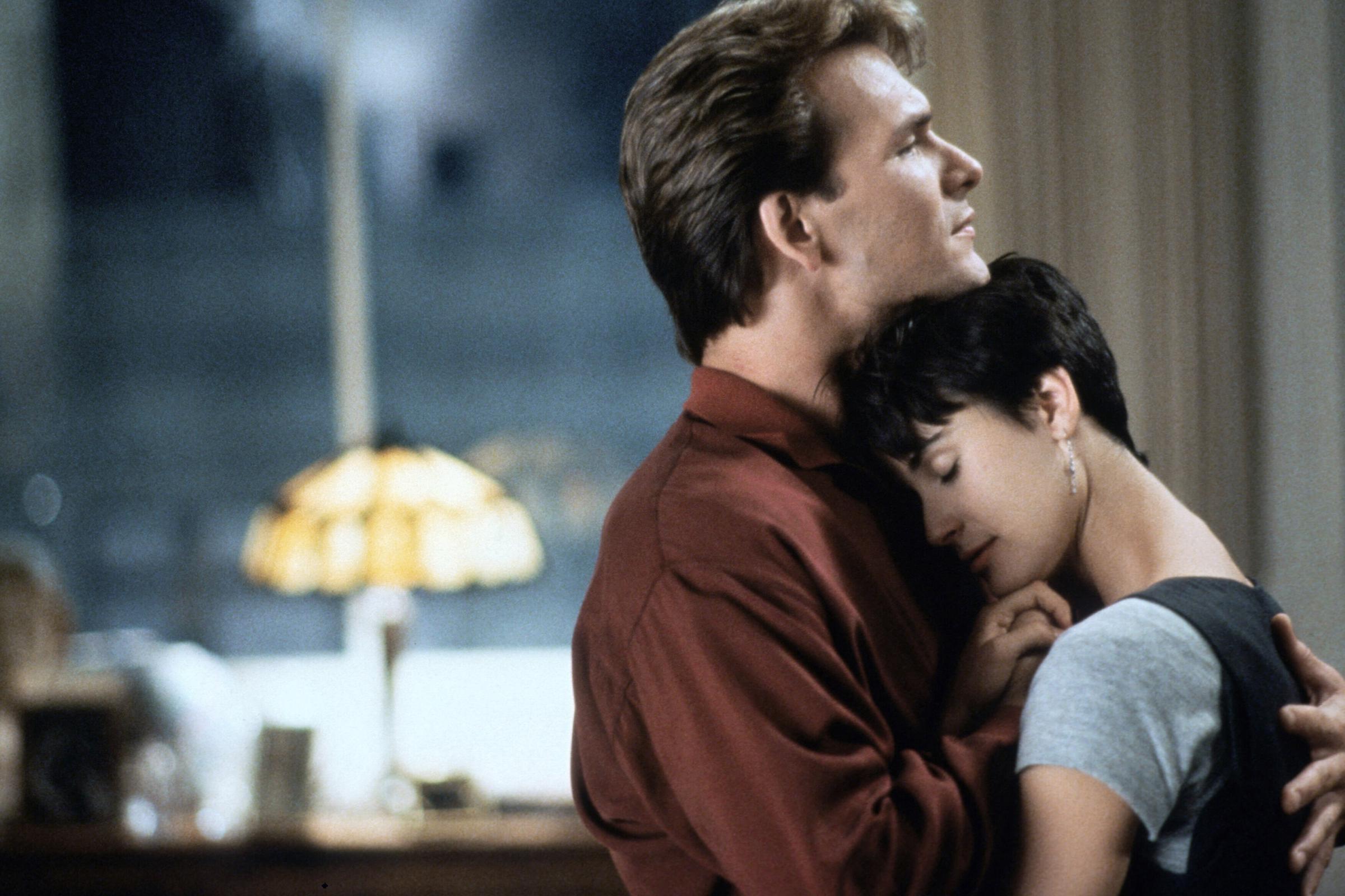 Sam holding Molly in a loving embrace as she lays her head on his chest. | Source: Getty Images