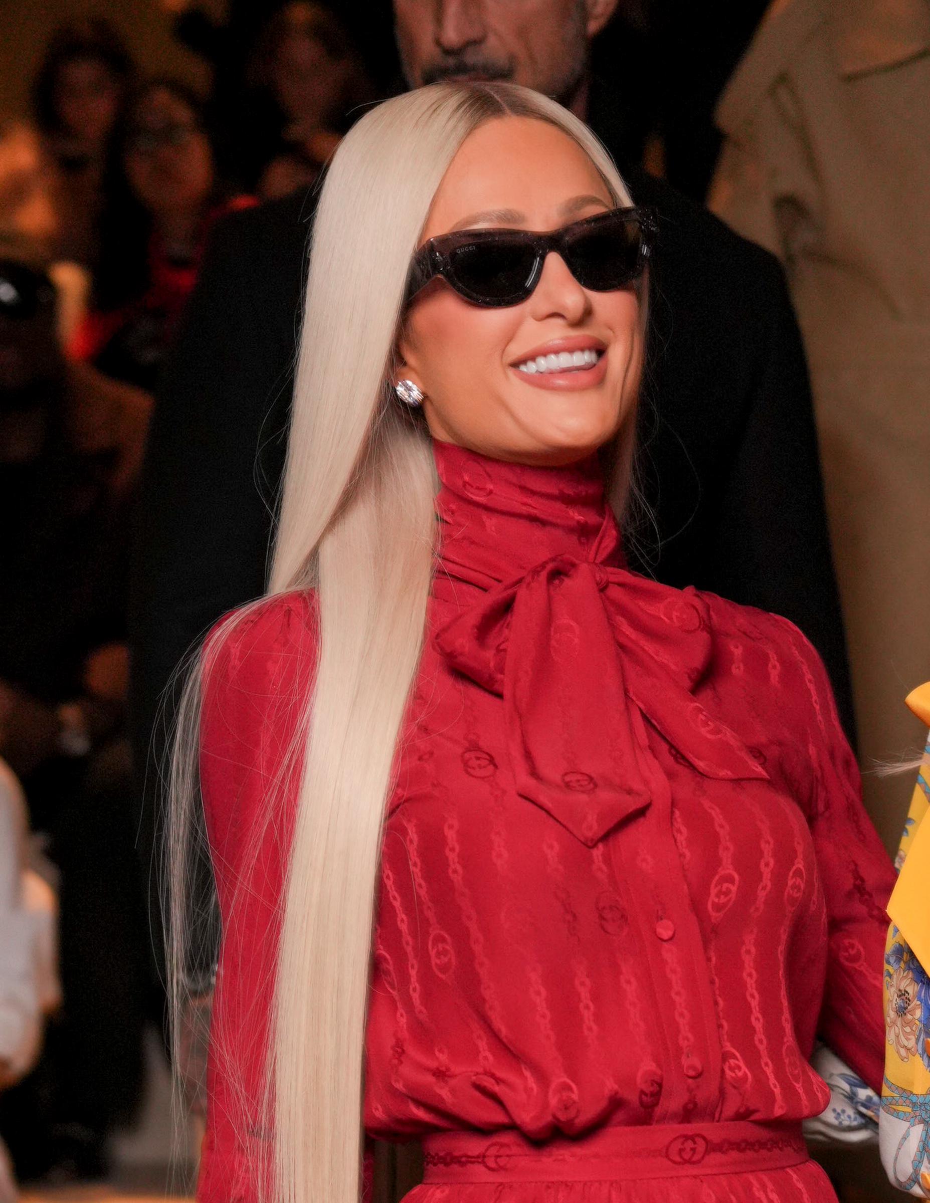 Ultra-long platinum hair emphasized just how strongly the color remains tied to Paris's celebrity image. That familiarity is precisely why her brunette Cherry Festival appearance caused such an immediate double take.
