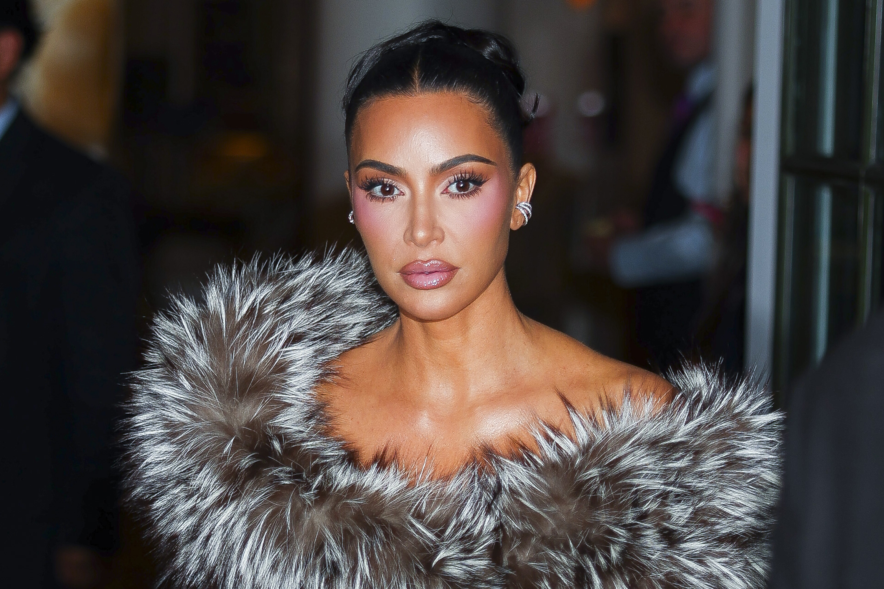 Kim Kardashian, 45, was seen in Midtown on October 27, 2025, in New York City. Her face featured an extremely taut, smooth forehead and mid-face, highly sculpted cheekbones accentuated by heavy blush, and full, precise lips set in a controlled expression.