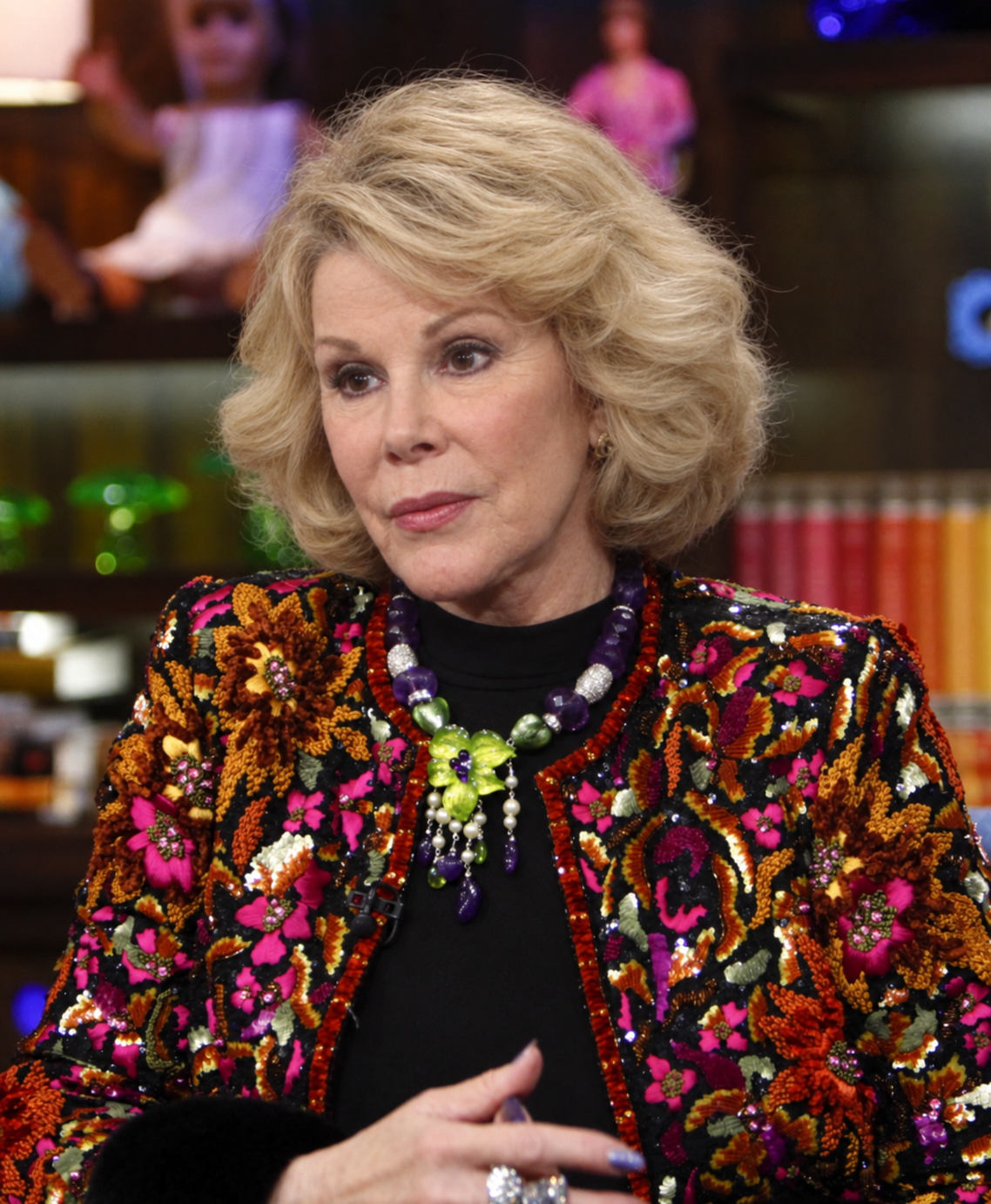 The AI version adds deeper facial lines and wrinkles while retaining Joan's layered blonde hairstyle, eye makeup, and overall look. | Source: ChatGPT