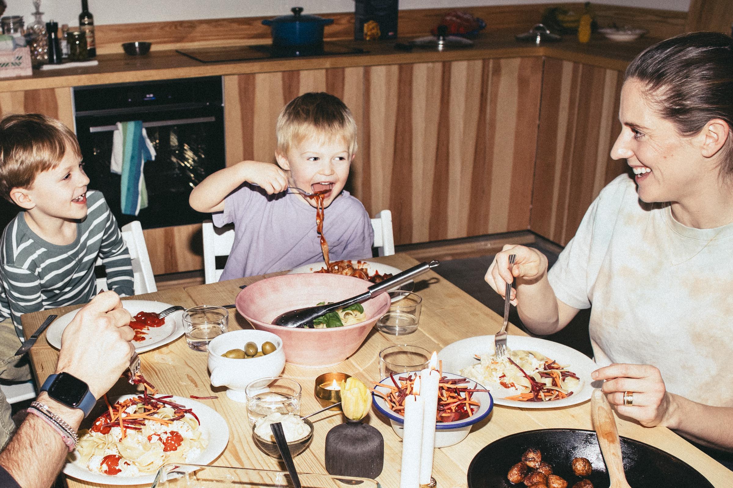 Family dinners can also be a chance to teach children small household responsibilities, such as setting the table or carrying their plates to the sink afterward. | Source: Getty Images.