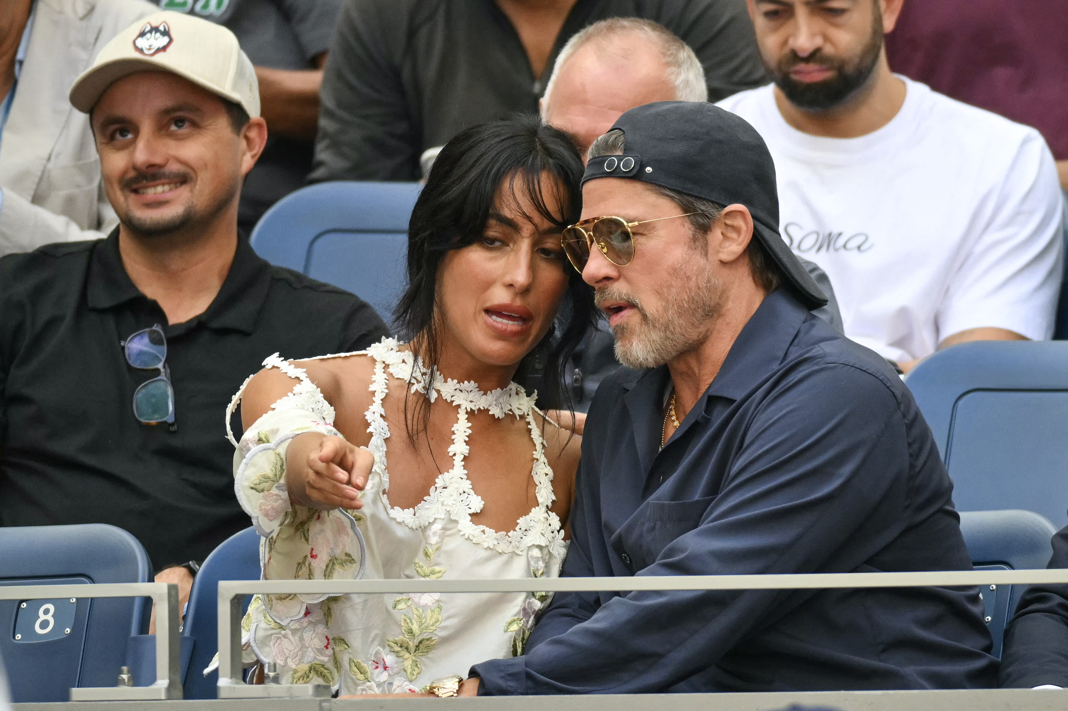 De Ramon leaned toward Pitt and pointed toward the court during the match. The couple were photographed chatting and interacting throughout their time in the stands.
