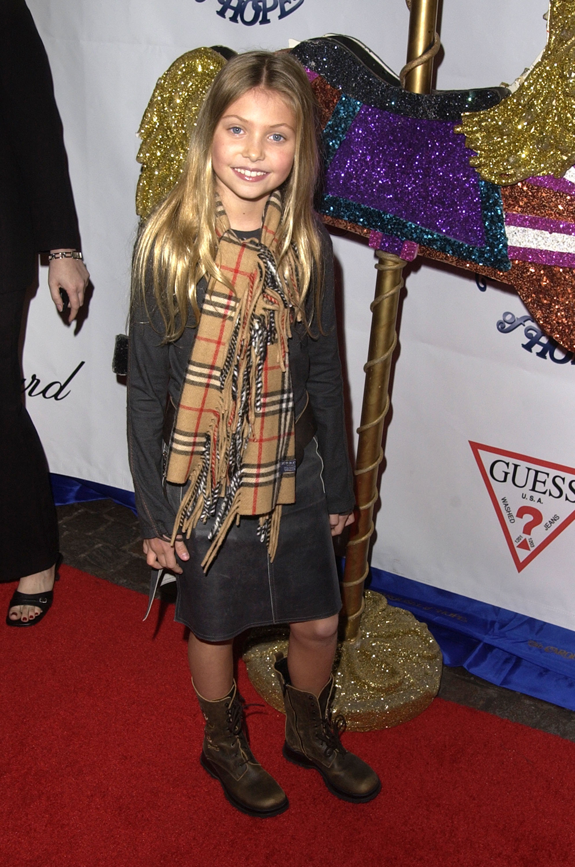 Taylor Momsen attends the 15th Carousel of Hope Ball at the Beverly Hilton Hotel in Beverly Hills, looking adorable in her outfit styled with boots and a scarf as she continues to grow taller in the spotlight.