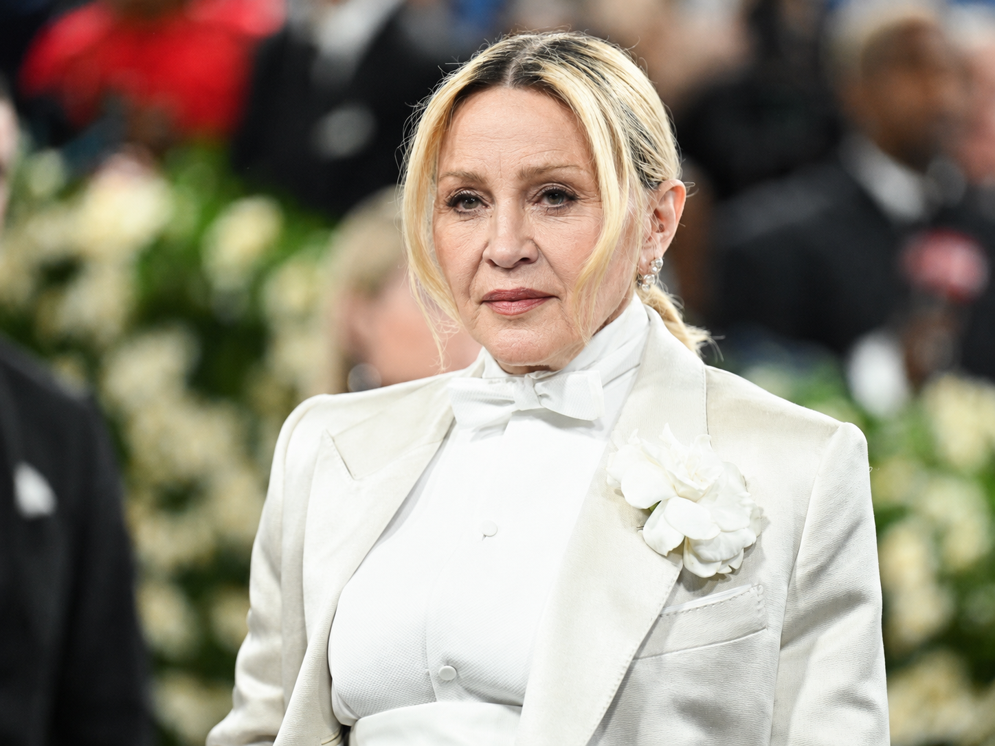 In the AI reimagining, Madonna's formal white look remains intact while her face is shown with more visible signs of aging. | Source: Chat GPT