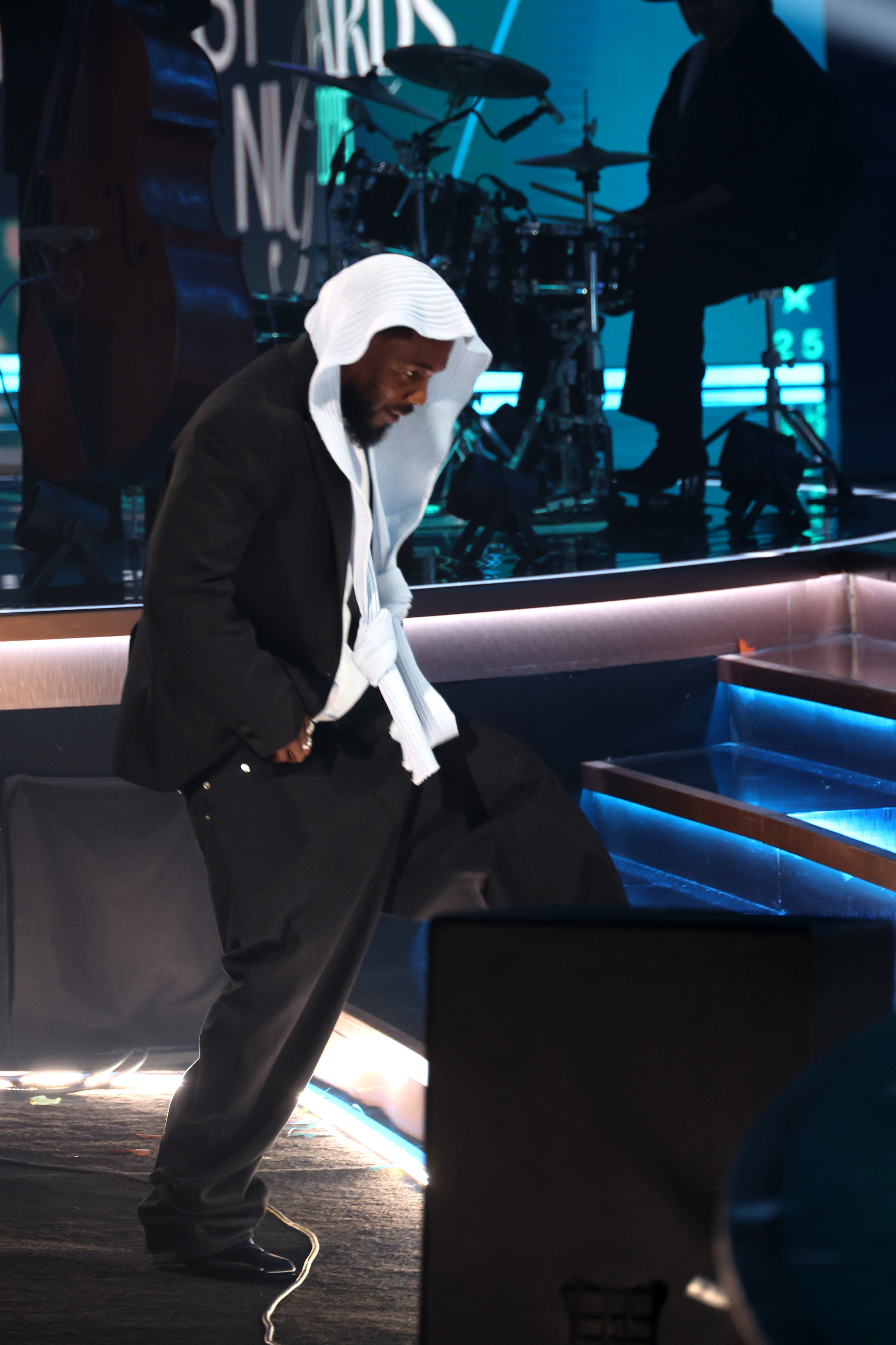 Kendrick Lamar steps onstage at the 2025 BET Awards. The rapper, known for his signature composure, kept his head bowed slightly as he made his way up the steps to accept one of his awards.