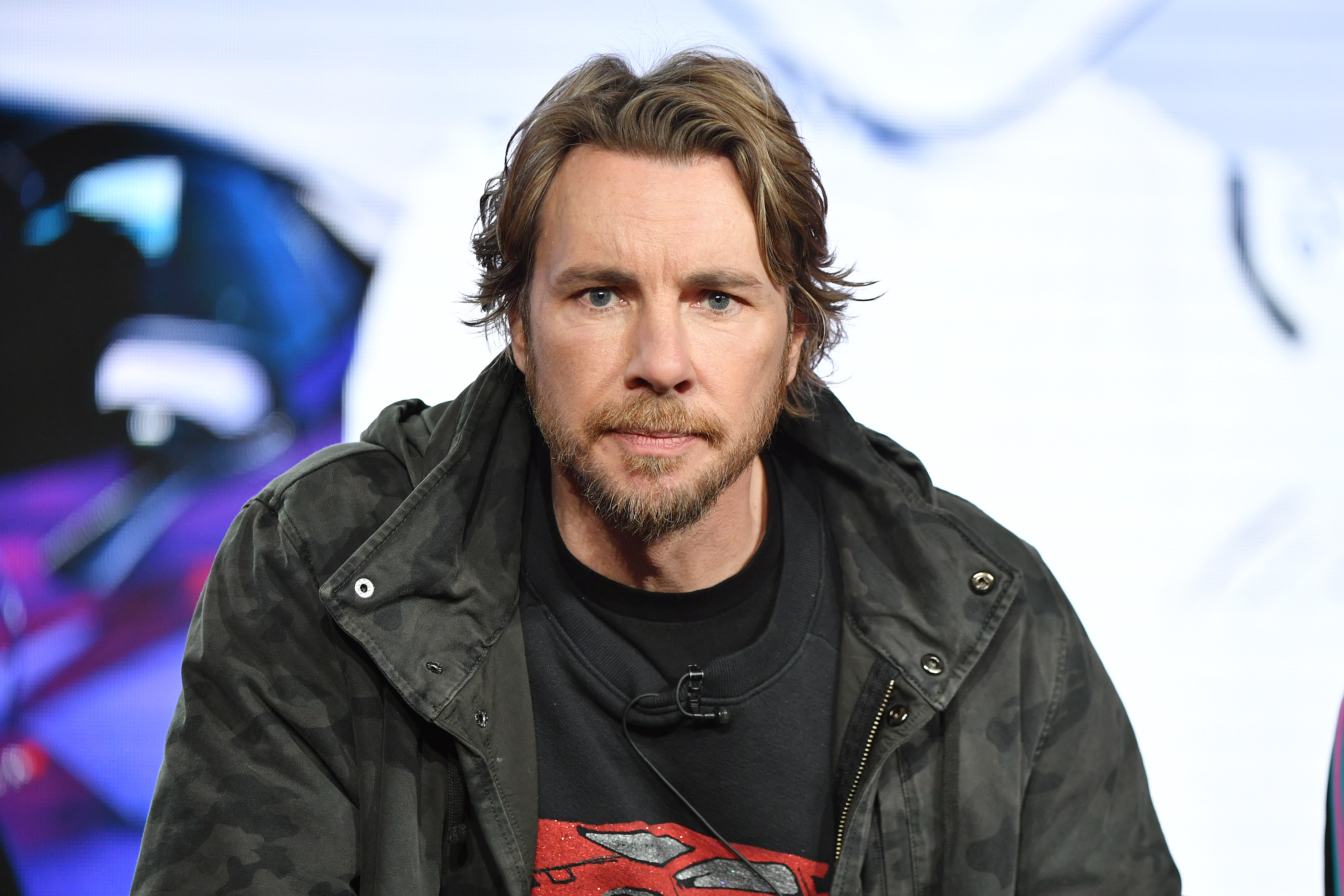 Dax Shepard takes the stage at the TCA Press Tour to speak about Top Gear America. In a camo jacket and graphic sweatshirt, he brings a cool, confident edge to the high-energy automotive series.