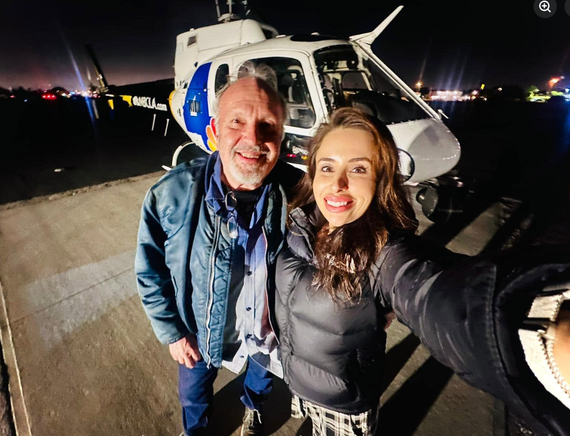 Eliana “Eli” Moreno and pilot George Marciniw pose in front of their news helicopter in a photo taken during their years working together in aerial news coverage. | Source: Facebook/George Marciniw