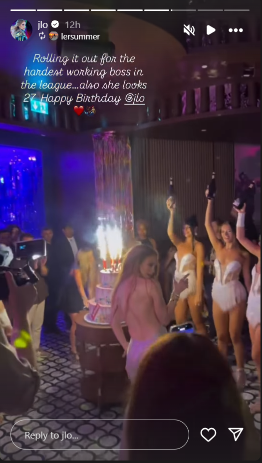 Jennifer Lopez, in a backless silver dress, receives a three-tier birthday cake while on a dance floor, from an Instagram story dated July 24, 2025. | Source: Instagram/jlo