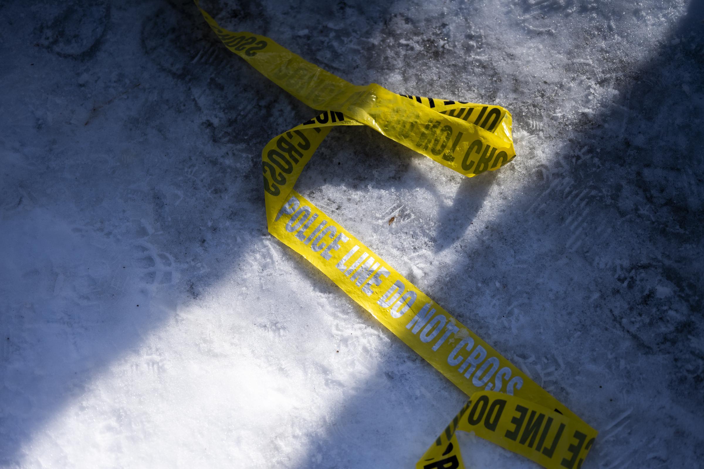 Police tape lies on the ground at the scene of a suspected shooting by an ICE agent during federal law enforcement operations on January 7, 2026, in Minneapolis, Minnesota | Source: Getty Images