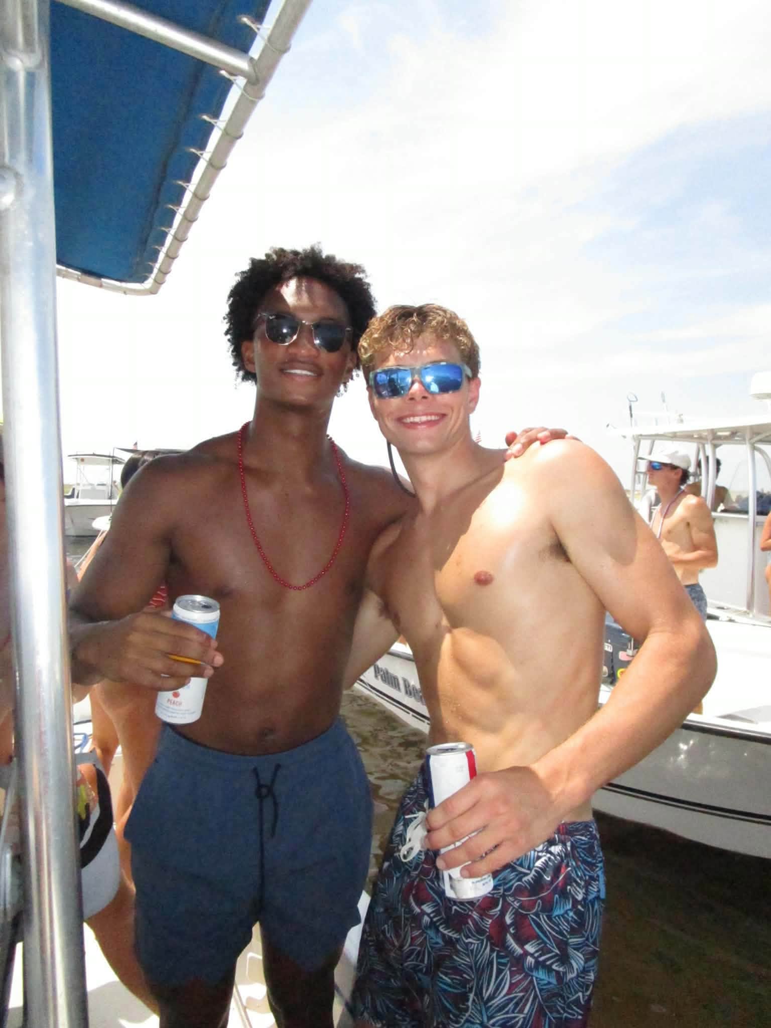 Nolan stands arm-in-arm with a close friend as other holiday boaters pass by in the background. His mother later shared these final snapshots online while addressing the community. | Source: Facebook/christine.wonsley