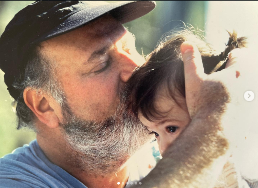 Rob Reiner kisses a young Romy's head, from a post dated March 6, 2022. | Source: Instagram/romyreiner