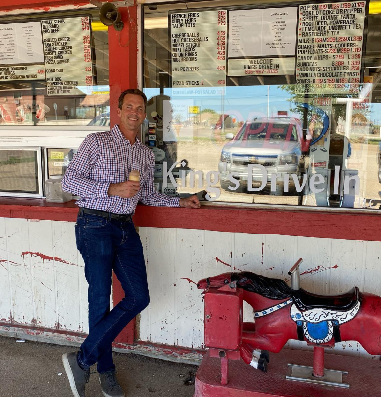 Ice cream in hand at a drive-in window, Bryon pauses mid-treat—nostalgia and roadside Americana in one frame. | Source: Instagram/sdbryonnoem