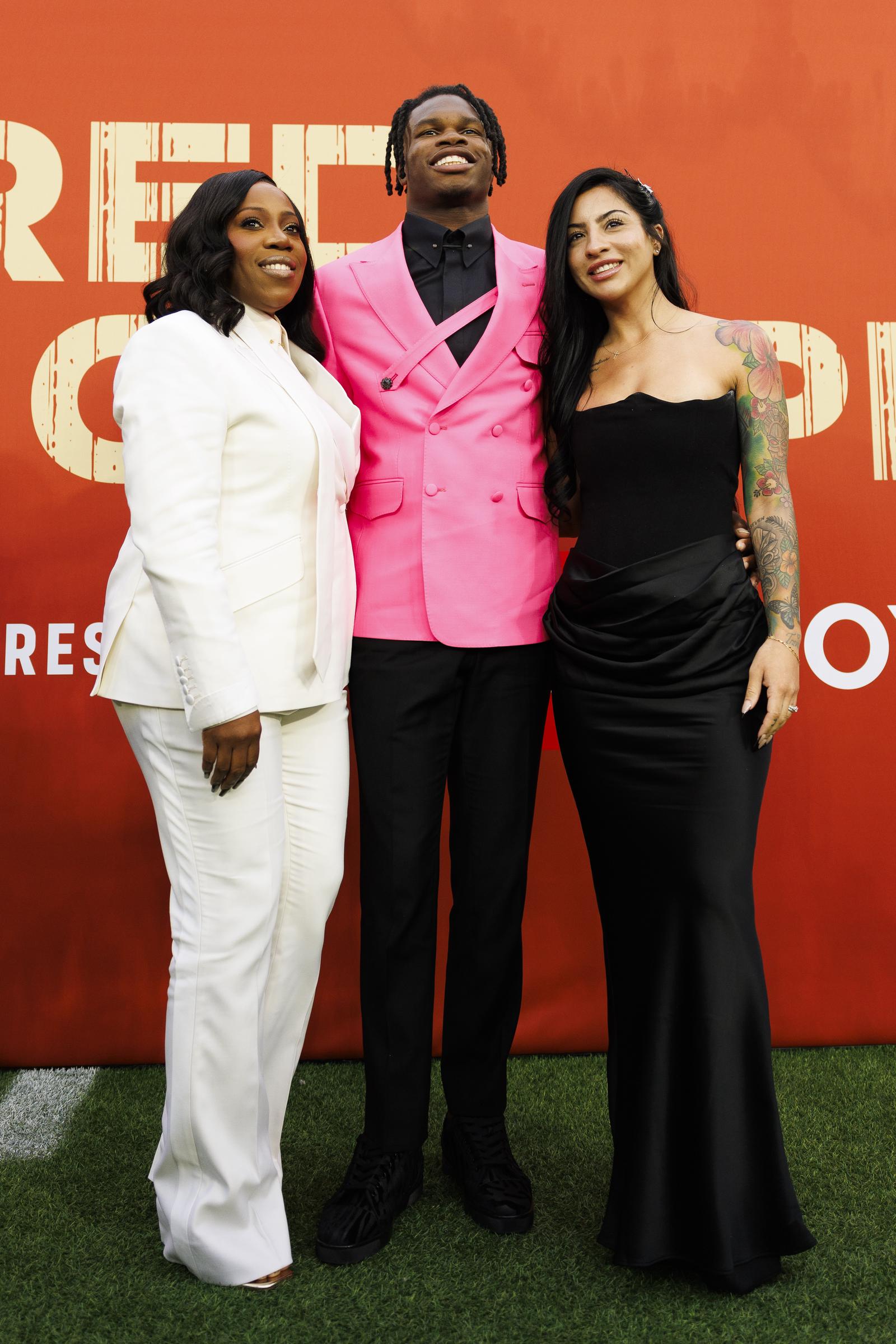 Ferrante Edmonds, Travis Hunter, and Leanna Lenee during the first round of the 2025 NFL Draft on April 24 in Green Bay, Wisconsin. | Source: Getty Images