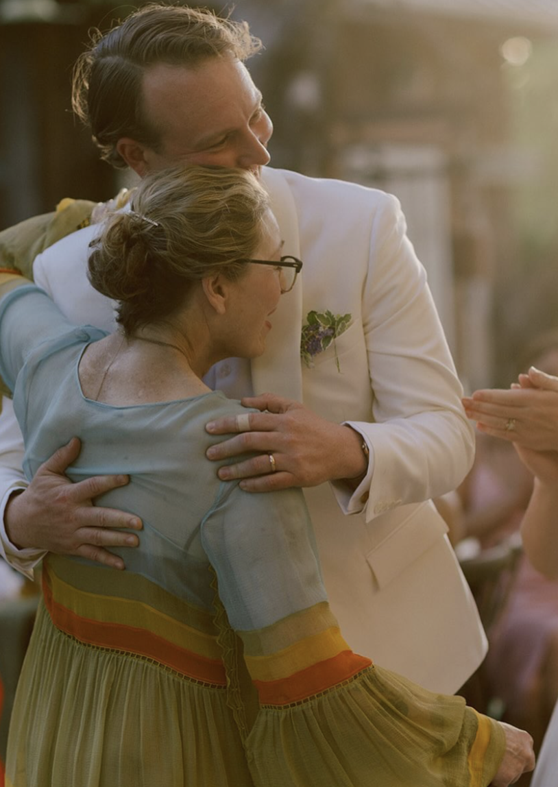 Kevin McEnroe embraced his mother, Tatum O'Neal, during his June 2025 wedding. His bride, Fern Cozine, later said she felt lucky to have "two of the coolest mothers-in-law in history," referring to Tatum and Kevin's stepmother, Patty Smyth. | Source: Instagram/@tatum__oneal
