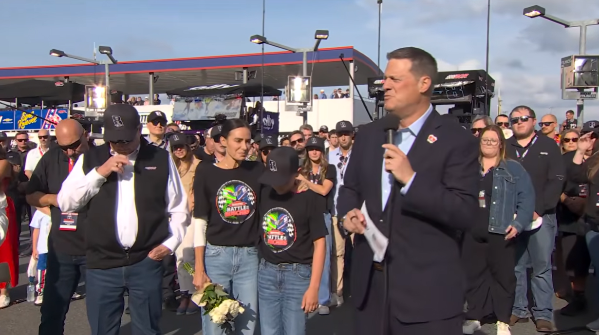 Steve O'Donnell speaks during the tribute ceremony for Kyle Busch as Samantha Busch and Brexton stand beside him on May 24, 2026 | Source: YouTube/NASCAR