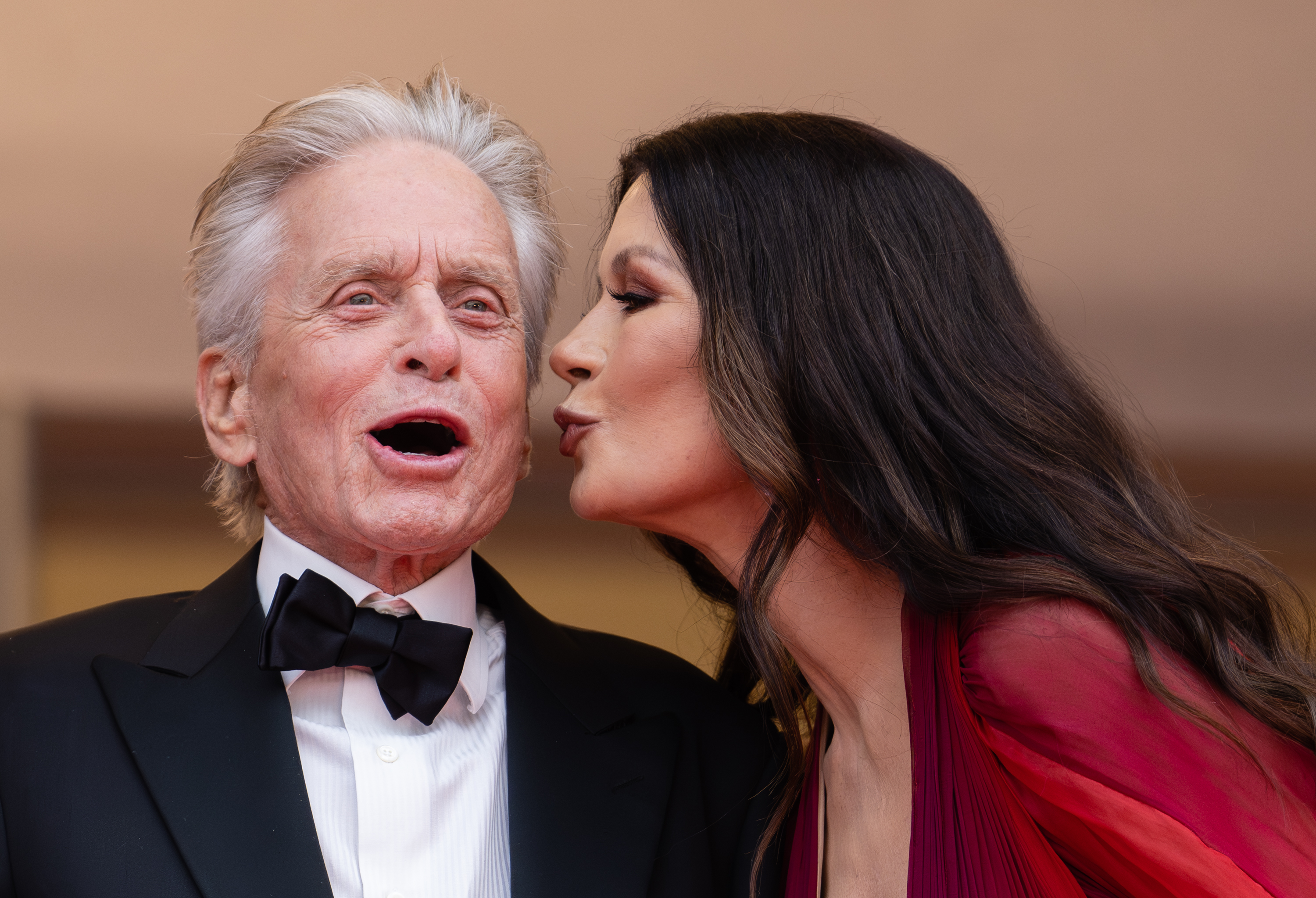 Michael and Catherine share a playful moment at the Cannes Film Festival in 2023, more than two decades into their marriage. Years later, Catherine's 25th-anniversary tribute reflected on a relationship that has stretched from their wedding day into decades of family life together. | Source: Getty Images