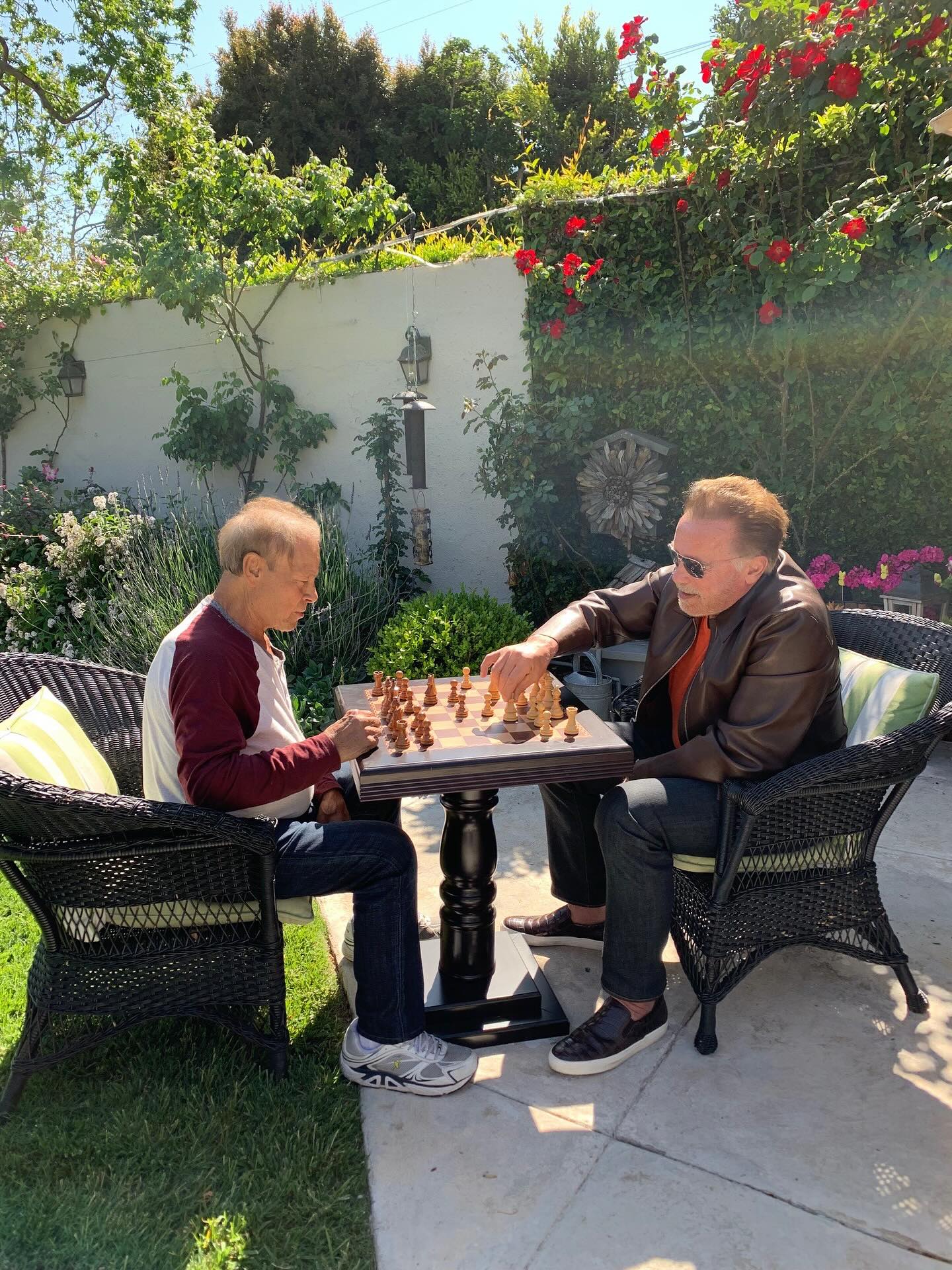 Arnold Schwarzenegger enjoys a sunny outdoor chess match in a photo posted on August 7, 2025 | Source: Facebook/arnold