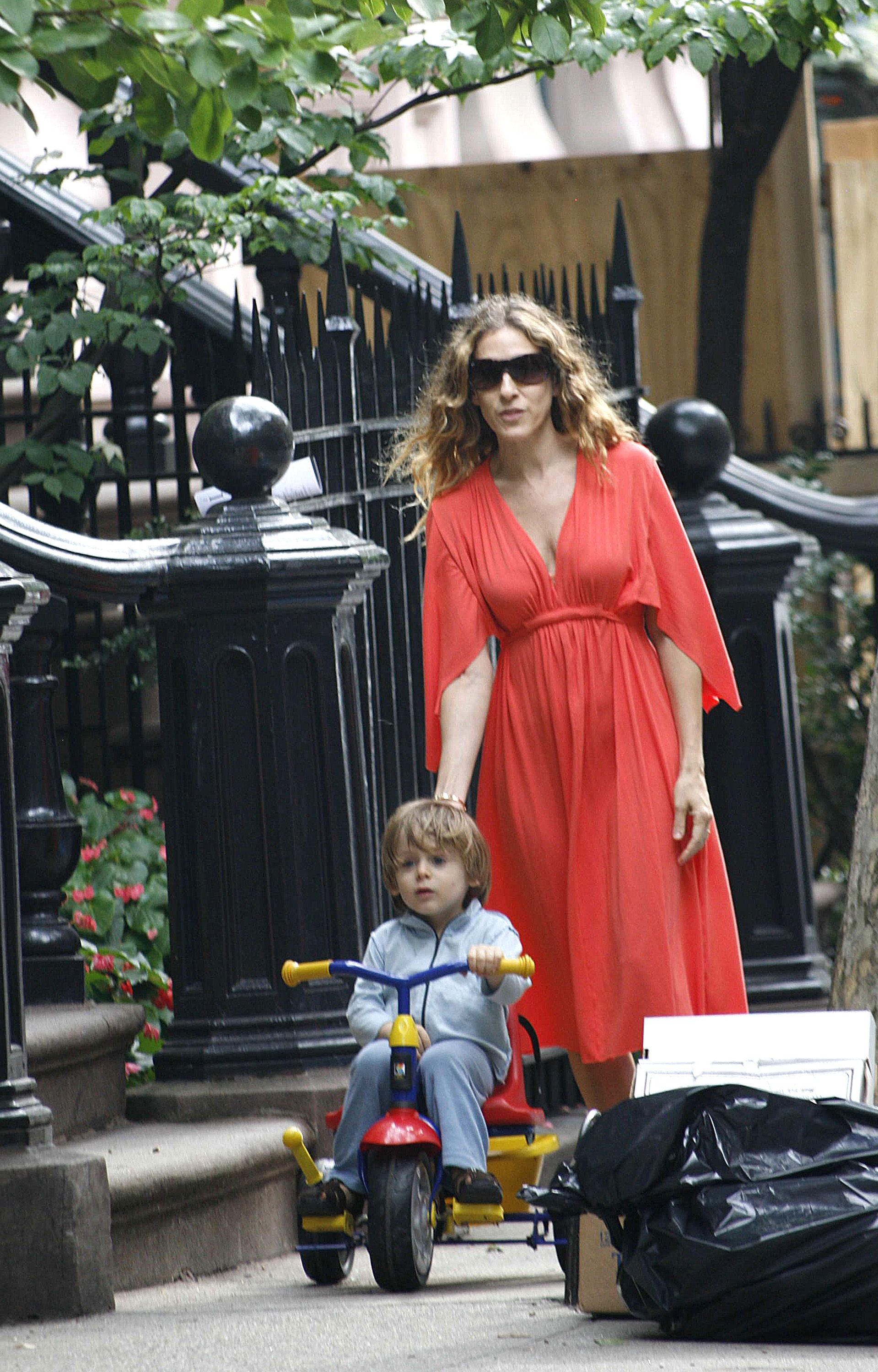 At three years old, James Wilkie Broderick rides a colorful tricycle along a New York City sidewalk while his mother, Sarah Jessica Parker, walks behind him. With his shaggy light-brown hair and toddler features still intact, the young boy appears carefree as he enjoys an everyday moment near the family's home.