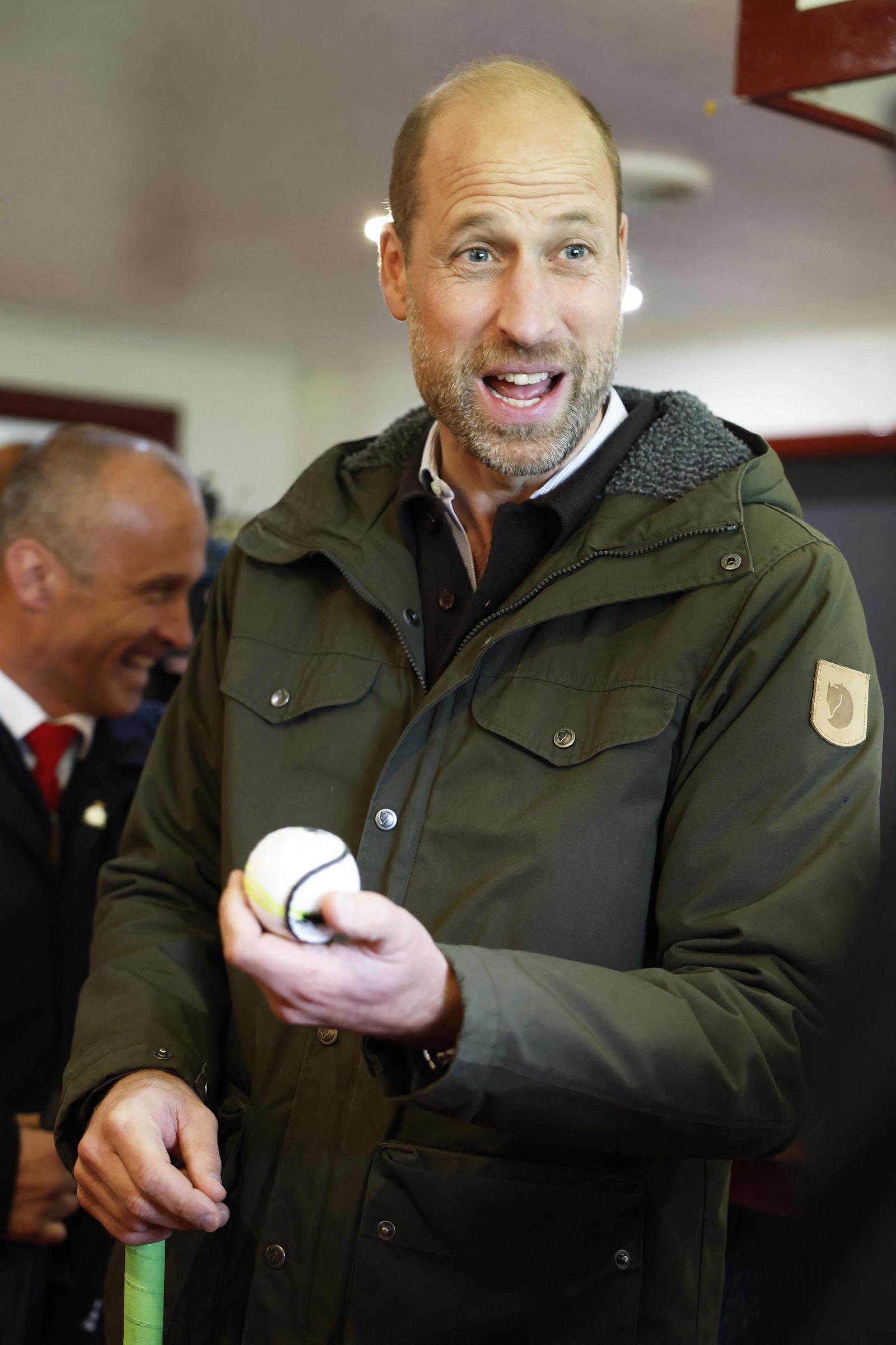 Prince William holds a shinty ball during the couple’s visit to Bute Shinty Club, offering a closer look at the traditional Scottish sport they explored during their day on the island. | Source: Getty Images