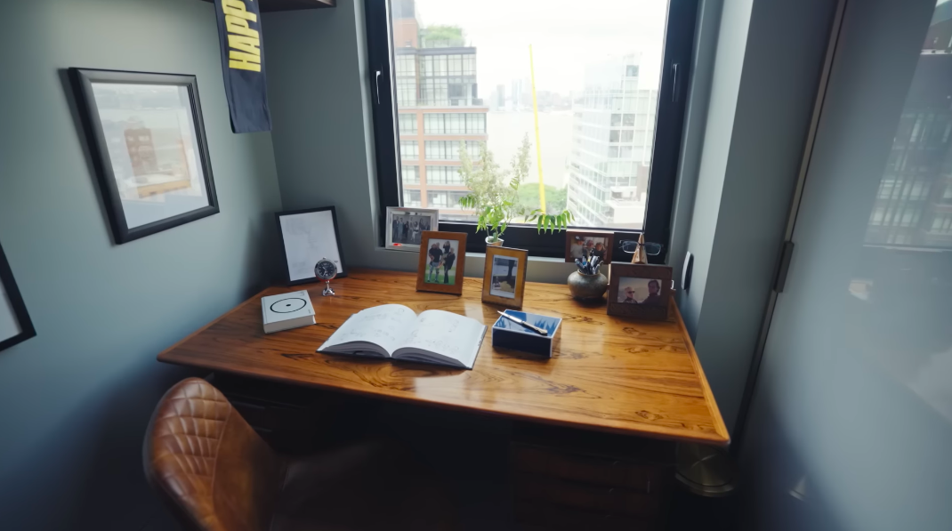 The desk may be where scripts and acting decisions happen, but the family photographs keep the workspace grounded. Christopher joked that he spends much of his time here looking at comics anyway. | Source: YouTube/Architectural Digest