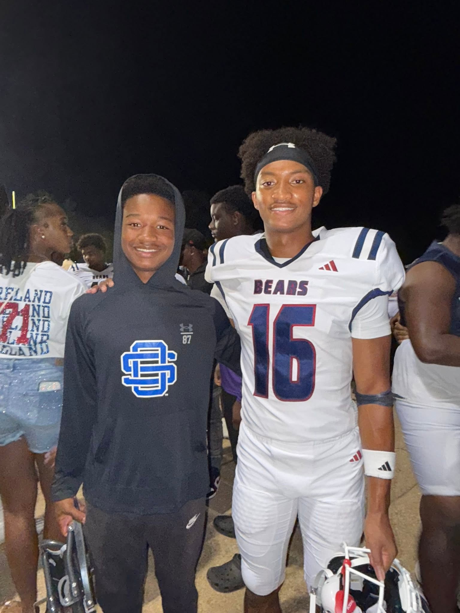 Nolan poses with his younger brother in a Bears uniform, both flashing wide smiles as the crowd celebrates behind them. | Source: Facebook/christine.wonsley