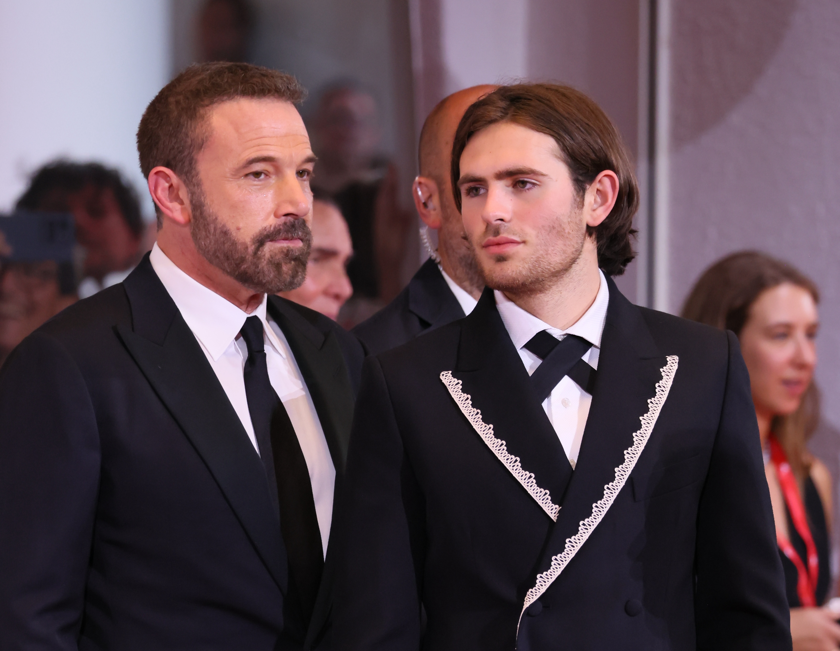 Sharing a quiet, focused moment amidst the bustling premiere atmosphere, Ben Affleck and nephew Indiana Affleck looked out toward the crowd with strikingly similar contemplative expressions at the "Company" screening during the 83rd Venice International Film Festival at Sala Grande on September 8, 2026. | Source: Getty Images
