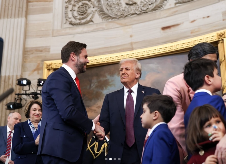 JD Vance shakes hands with President Donald Trump following the ceremony, as his wife, children and other attendees stand nearby inside the ceremonial room. | Source: Instagram/vp