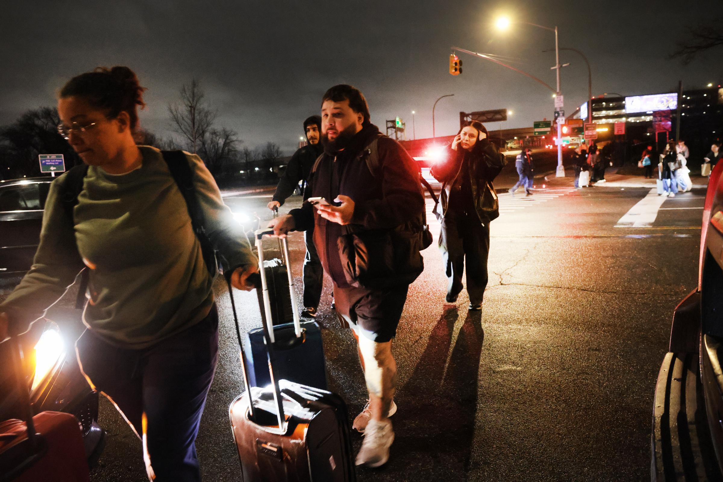Travellers look for rides after LaGuardia Airport was closed following a collision between an Air Canada Express plane and a fire truck on March 23, 2026, in New York City | Source: Getty Images