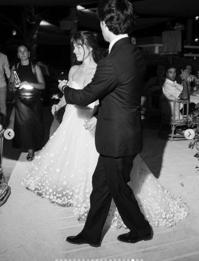 Paula Bruss-Lee and her groom shared a joyful dance after the ceremony, with her strapless gown’s delicate floral details and sweeping princess-like train on full display. | Source: Instagram/thierryjoubertphotography