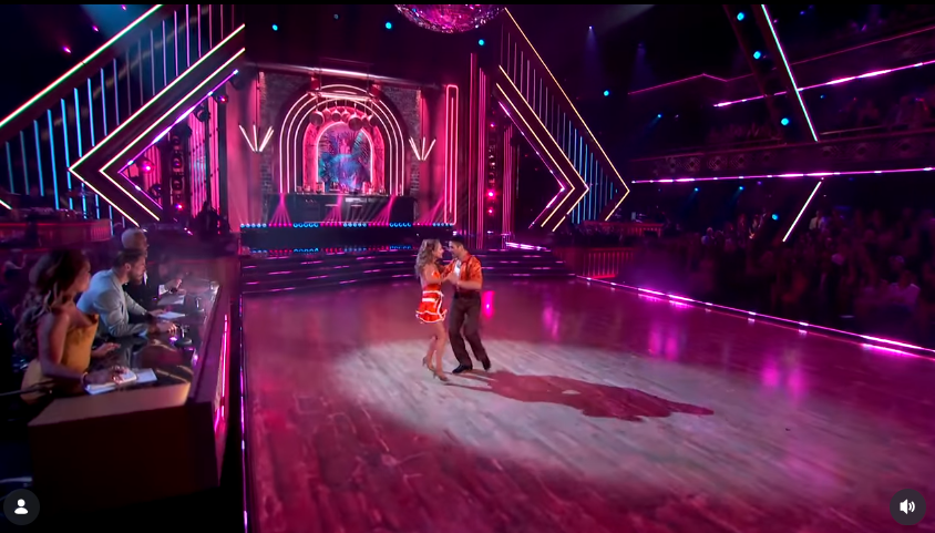 Giada De Laurentiis and Alan Bersten perform their salsa across the Dancing with the Stars ballroom during Viral Hits Night, with the judges watching from the side of the floor. The routine sparked a wave of reactions from viewers, some of whom defended Giada and questioned whether the judging reflected what they saw in her performance. | Source: Instagram/dancingwiththestars