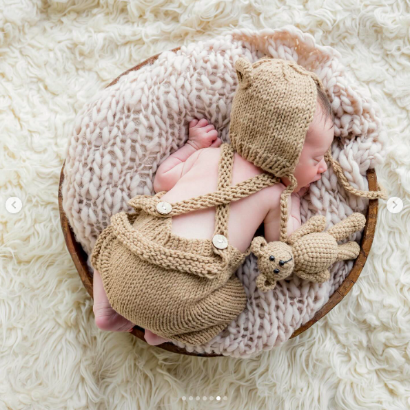 Alexander Trump Boulos sleeping in a blanket-covered wooden bowl. | Source: Instagram/tiffanytrump