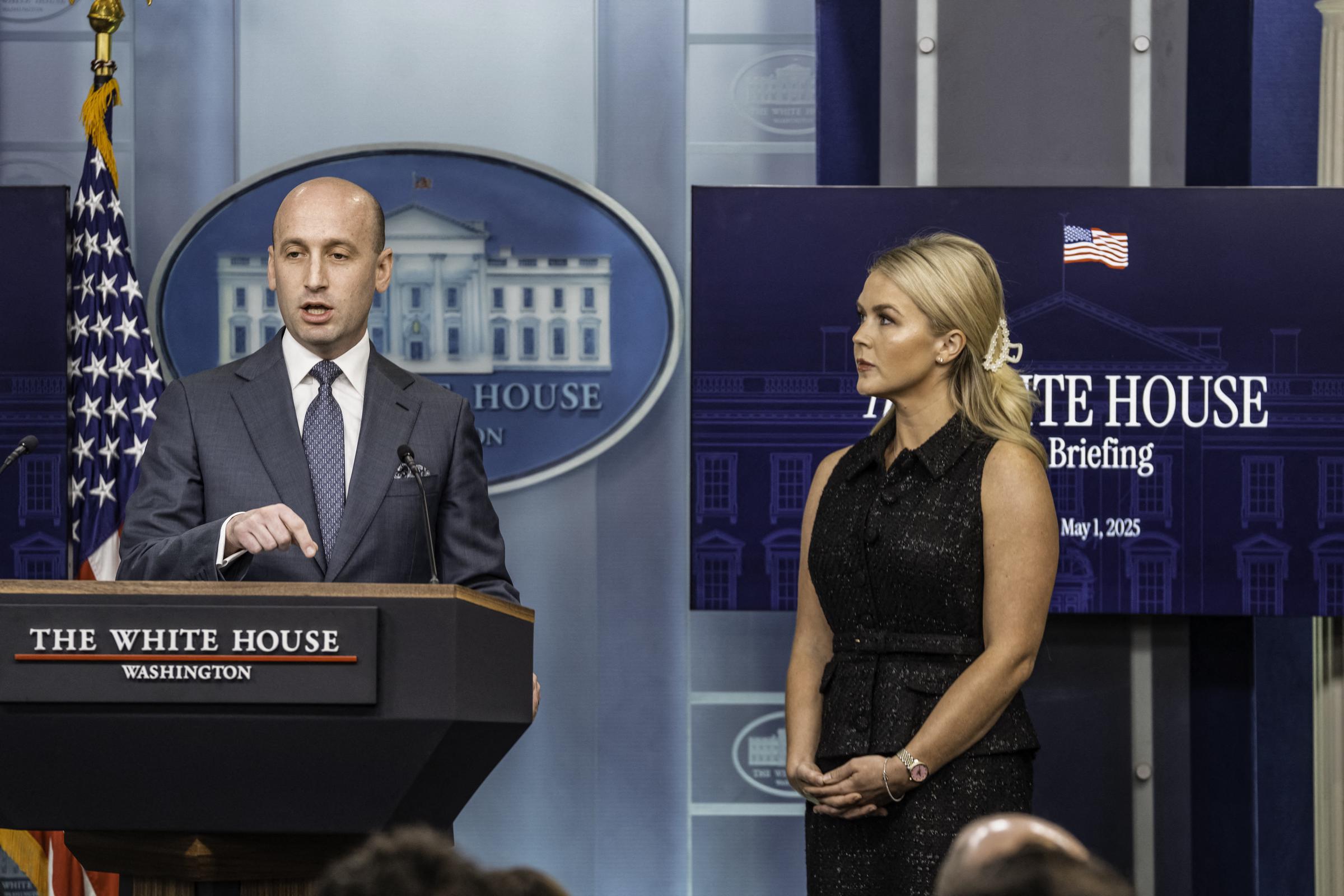Karoline Leavitt looks on as Stephen Miller addresses the media | Source: Getty Images