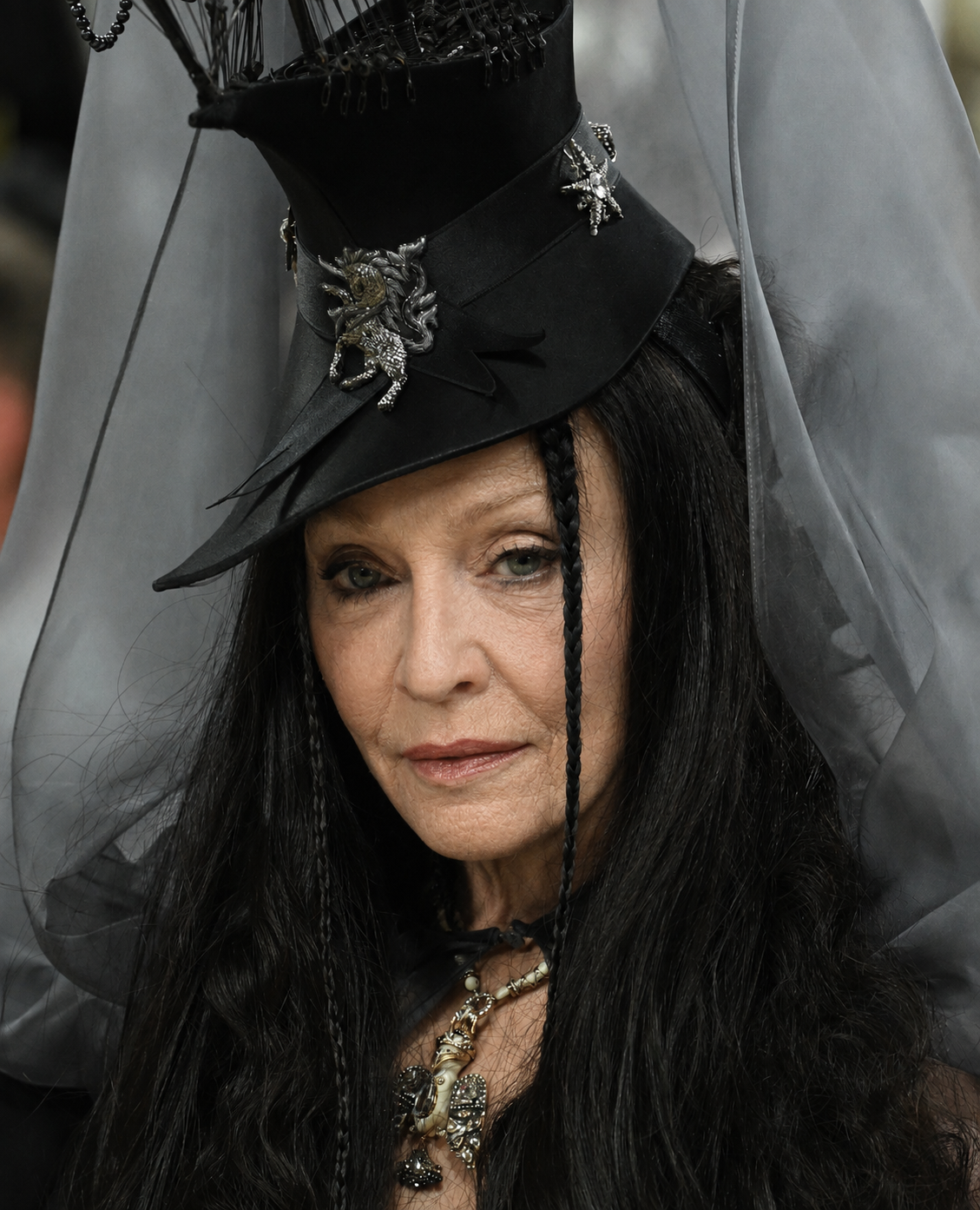 The digitally reworked portrait preserves Madonna's dramatic hat, veil and dark hair while imagining a more visibly aged facial appearance. | Source: Chat GPT