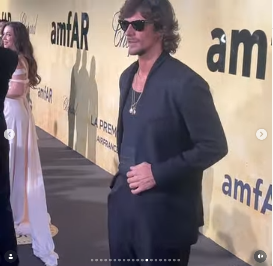 Jake Hall poses in an all-black outfit and sunglasses at an amfAR event. | Source: Instagram/jakehall