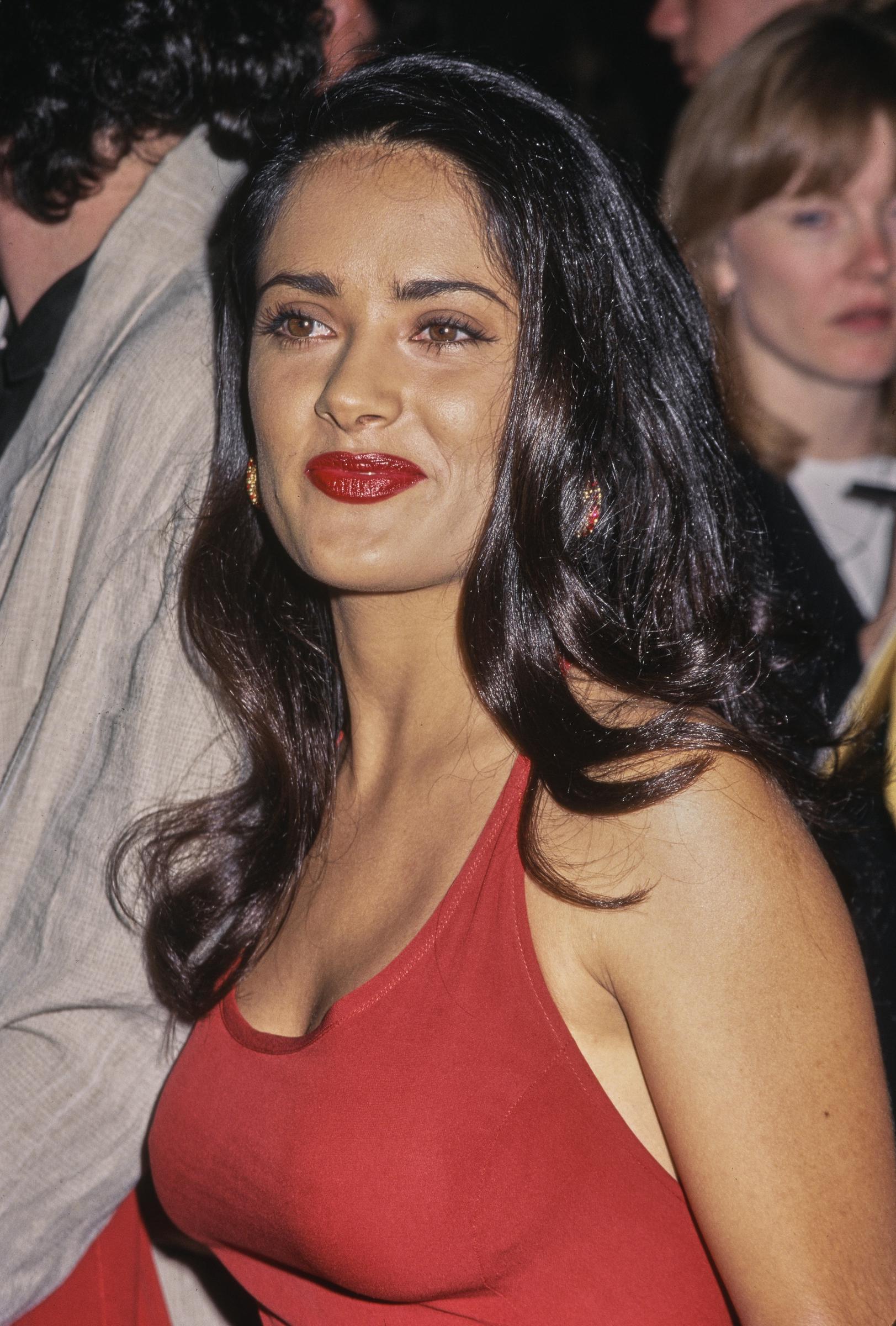 Salma Hayek wore her long, dark hair loose for the August 1995 premiere of "Desperado" in Los Angeles. Decades later, the actress has spoken openly about embracing her white strands, even sharing a simple trick for covering them without hair dye. | Source: Getty Images