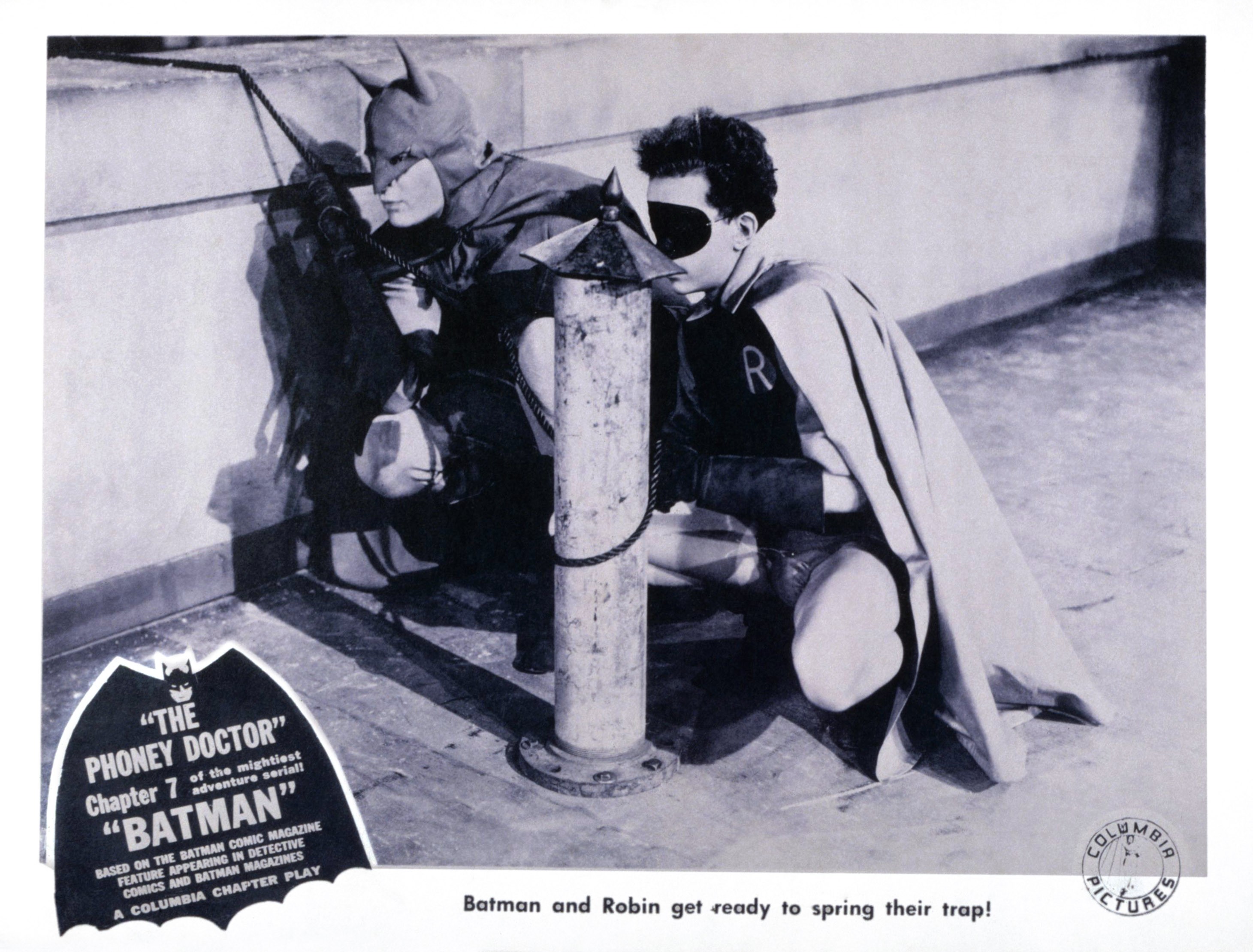 The first actor to portray Batman in live action and Douglas Croft as Robin prepare to spring a trap in this lobby card from Columbia Pictures' 1943 "Batman" serial. | Source: Getty Images
