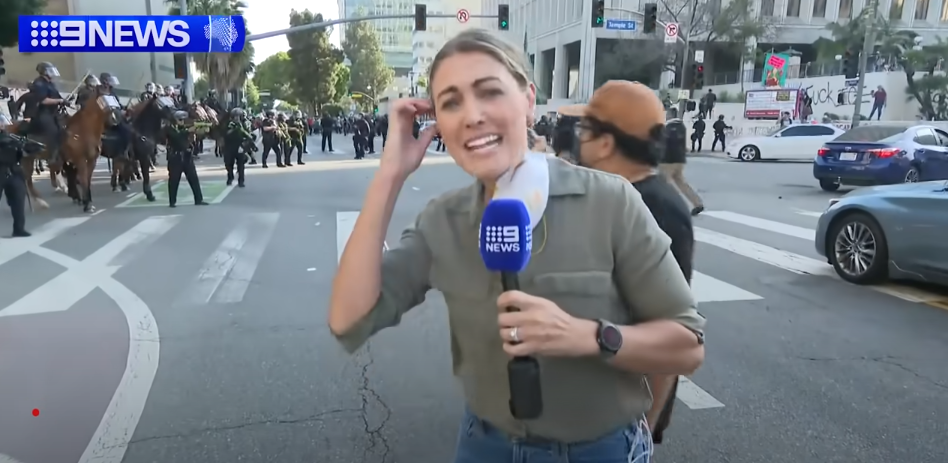Lauren Tomasi reporting from Downtown Los Angeles during confrontations between the U.S. National Guard and protestors on June 8, 2025 | Source: Youtube/9 News Australia
