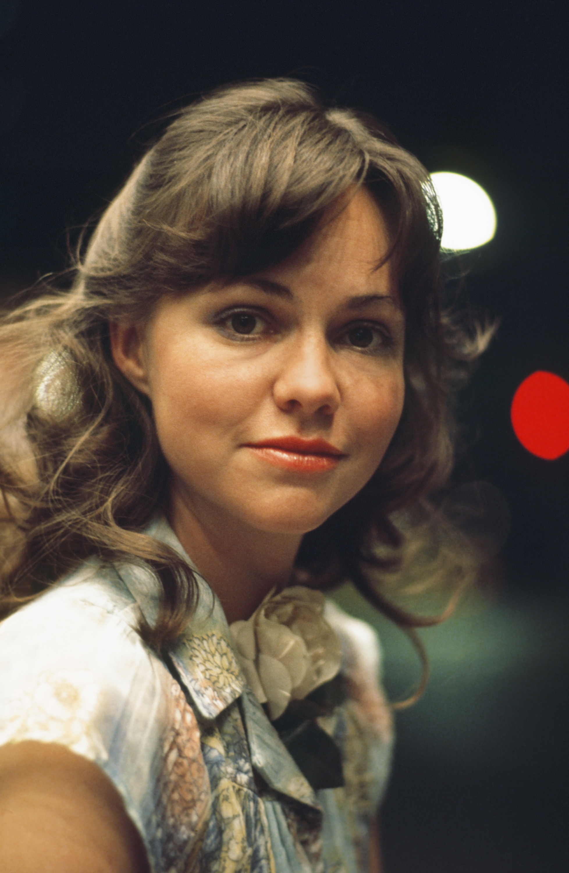 Sally Field as Sybil on "The Big Event," wearing minimal makeup with her hair parted at the center. Even in the look of the character, her beauty shines through.