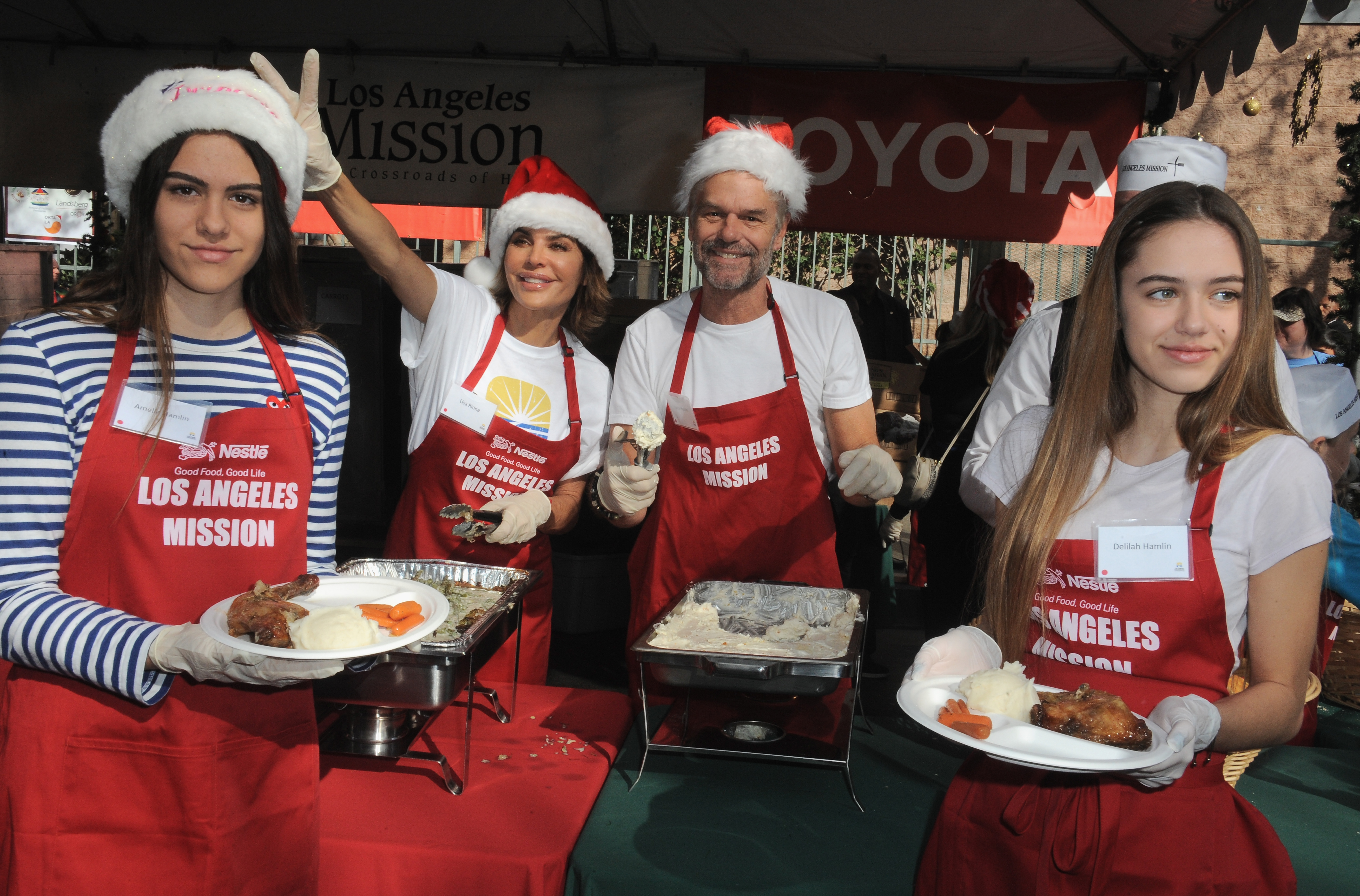 Lisa Rinna, Harry Hamlin and daughters Delilah and Amelia at the Los Angeles Mission Christmas Eve Event for Skid Row Homeless held at Los Angeles Mission on December 24, 2014 in Los Angeles, California. | Source: Getty Images