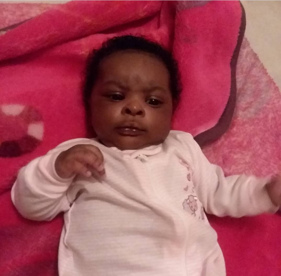 A close-up of one of Shamar Elkins’s children shows the baby lying on a soft pink blanket, gazing forward with a calm, curious expression. | Source: Instagram/pughnene