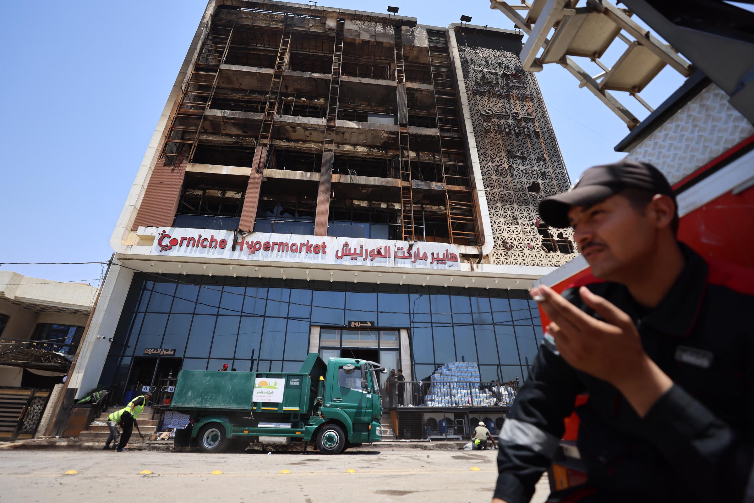 View of the Hyper Mall building and the Corniche Hypermarket in Kut, Iraq, on July 17, 2025, with extensive fire damage visible. | Source: Getty Images