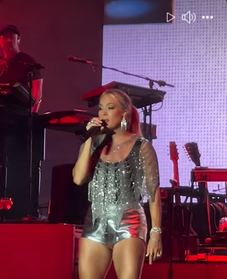 Carrie Underwood performs in a metallic ensemble at the event, as seen from a video post dated November 30, 2025.| Source: Facebook/thecountrywire