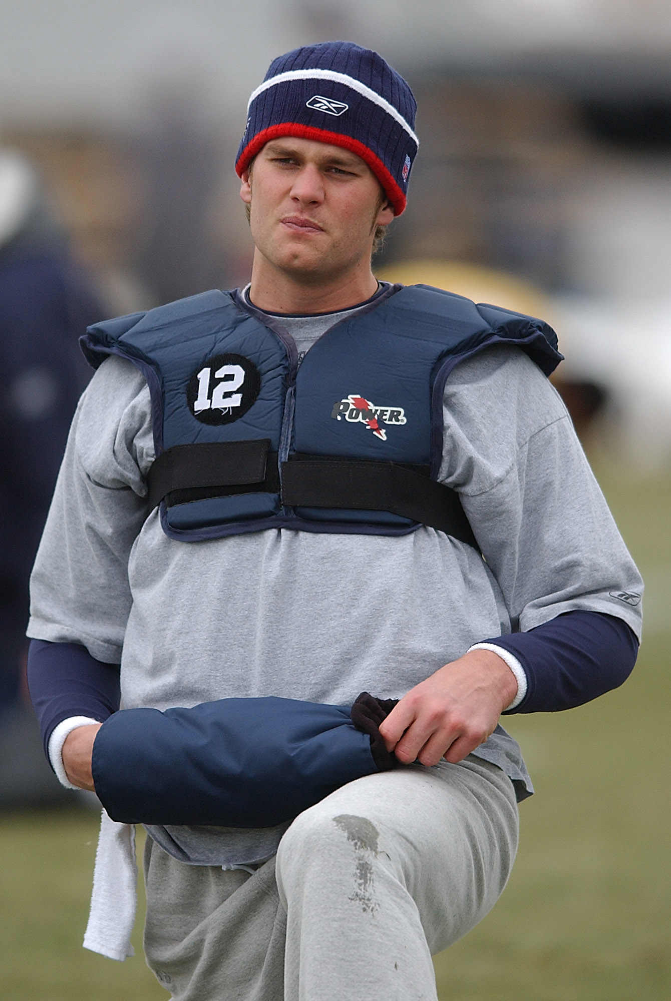 Tom Brady stretched during practice at Gillette Stadium's practice field on January 11, 2006, as the Patriots prepared for the postseason. The training session provided another glimpse of the quarterback's appearance in his early playing years, before discussions about alleged cosmetic enhancements and facial changes became increasingly common.
