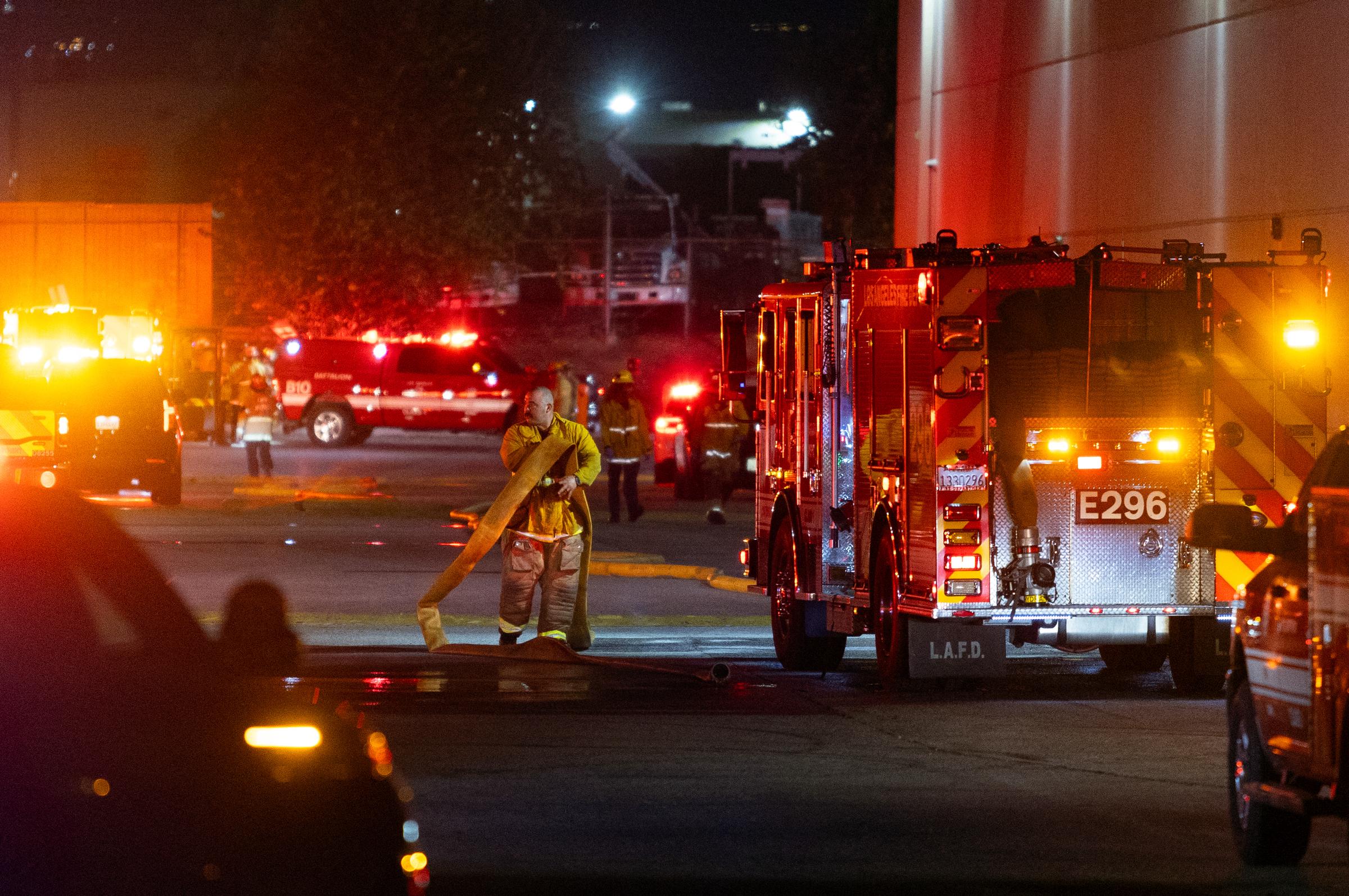 Firefighters respond at the scene of the fatal helicopter crash in Chatsworth, Los Angeles, as emergency crews work amid the wreckage and flames. | Source: Getty Images