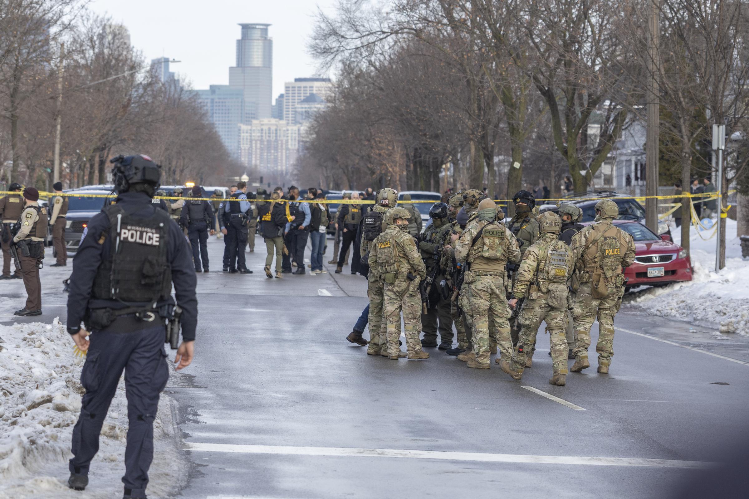 ICE agents stand at the scene where ICE agents fatally shoot a woman earlier in the day in Minneapolis, Minnesota, United States, on January 7, 2026. | Source: Getty Images