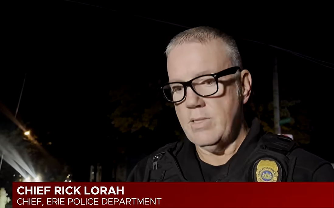 Police Chief Rick Lorah speaks to reporters at night following the deadly shooting in Erie, Pennsylvania, wearing his uniform and badge. During his remarks, he described the scene as horrific, noting that people had been killed both inside and outside the residence as investigators worked to piece together what happened. | Source: YouTube/Erie News Now