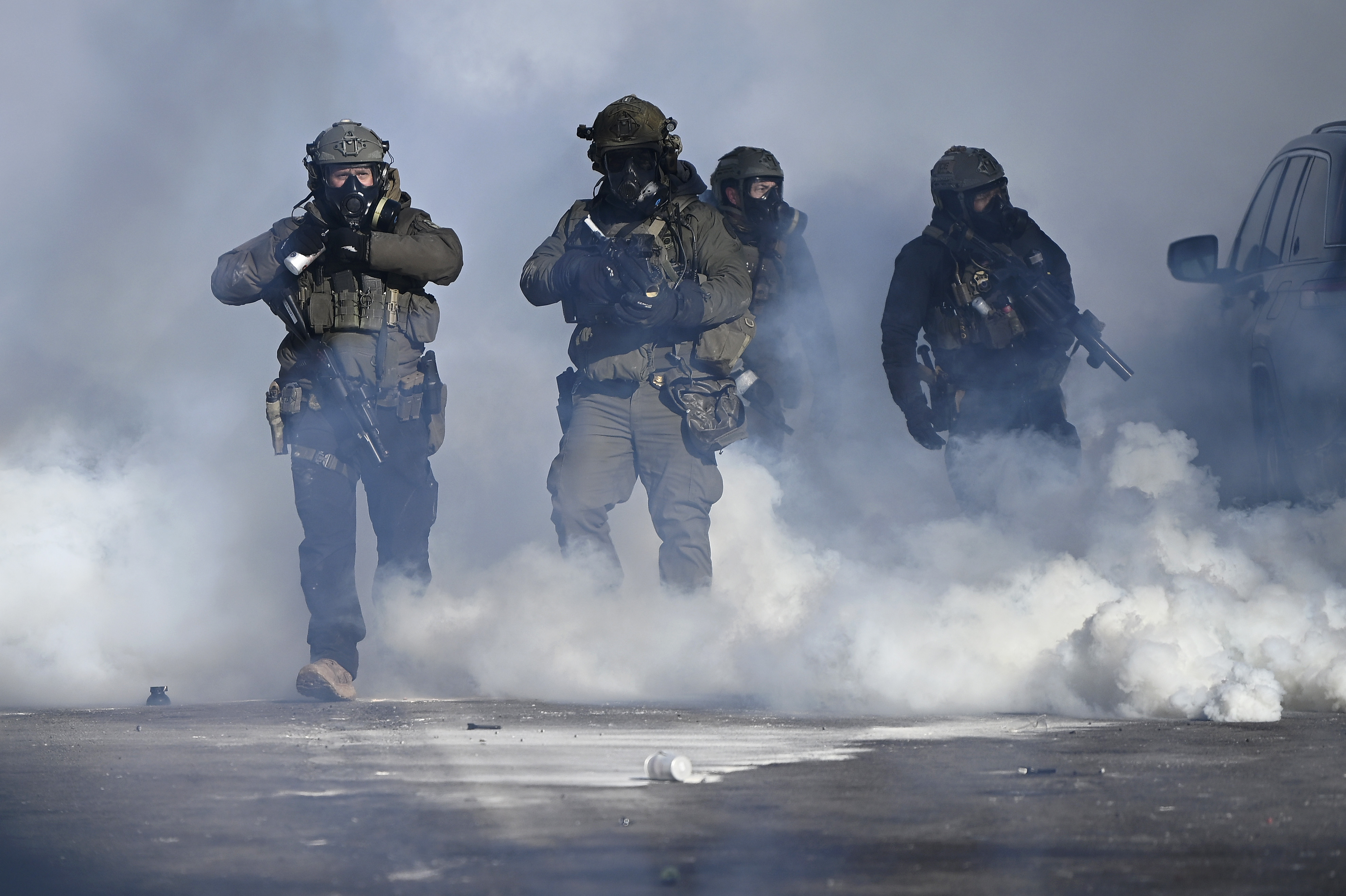 Federal agents point weapons amid tear gas fired at protestors in Minneapolis, Minnesota  on January 24, 2026. | Source: Getty Images