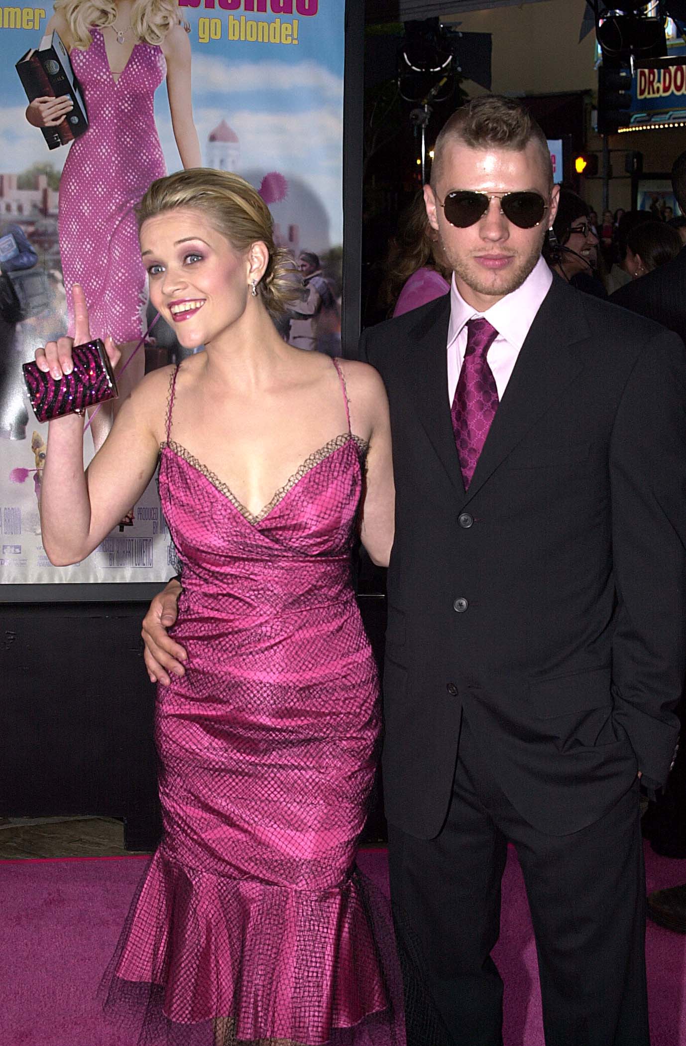 Reese Witherspoon and Ryan Phillippe attend the "Legally Blonde" premiere in 2001 at Mann Village Theatre, with her in a sparkling pink dress and him in a black suit and sunglasses. | Source: Getty Images