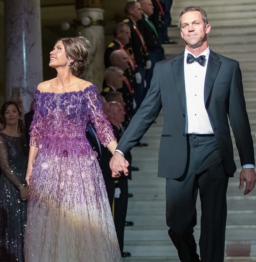 Kristi and Bryon Noem step out hand in hand in formal eveningwear, projecting a poised, public-facing elegance softened by the quiet connection between them. | Source: Instagram/sdbryonnoem